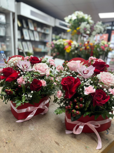 Heart Hat Box - Beautiful large heart shaped hat boxes with pink Mondial roses and red naomi roses along with cymbidium orchid heads, gyp, hypericum berries and spray carnations.
