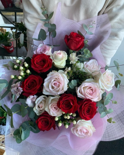 Pink and Red Rose Bouquet - A Beautiful mix of pale pink and pure red roses along with fresh eucalyptus and berries.
