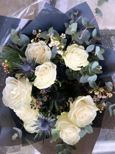 Bouquet of Joy - Our best seller every year, an elegant winter mix of white roses, fresh spruce, thistles, lisianthus and eucalyptus.