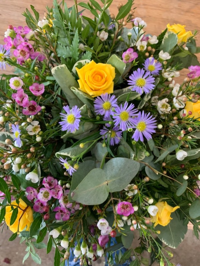 Country style tribute - A lovely grave/funeral tribute with country style stems such as fresh eucalyptus, wax flower, september flower, yellow roses etc.