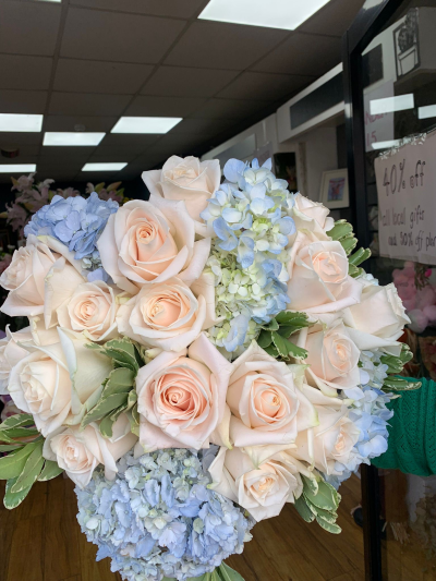 Exquisite whites and blues bouquet - A breathtaking bouquet including a variant of rose called soul and beautiful blue hydrangeas with seasonal foliage.