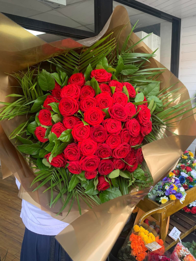 Giant red rose bouquet - Outstanding long stem red rose bouquet with 50 large headed roses and foliage